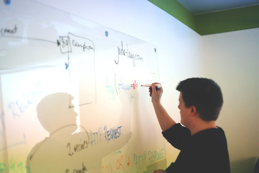 Person writing on a board